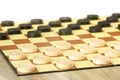 Checkers or draughts is a board game. Close Up of wooden round checkers. white background