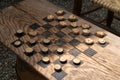 Checkers game made from wood and corn cob pieces