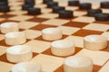 Checkers on a wooden board