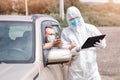 Checking and disinfecting car for virus COVID-19 and bubonic plague border of city and country. Doctor in biohazard suit Royalty Free Stock Photo