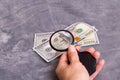 Checking dollar bill for authenticity with magnifying glass Royalty Free Stock Photo