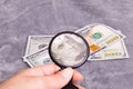 Checking dollar bill for authenticity with magnifying glass Royalty Free Stock Photo