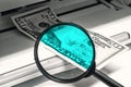 Checking dollars for fake. Magnifying glass against the background of a banknote and printer. Royalty Free Stock Photo
