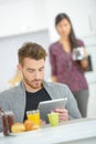 Checking e-mails during breakfast Royalty Free Stock Photo