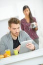 Checking e-mails during breakfast Royalty Free Stock Photo