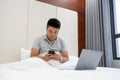Checking emails on smart phone in hotel room Royalty Free Stock Photo