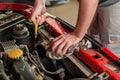 Checking for engine oil on a car Royalty Free Stock Photo