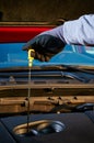 Checking engine oil level in modern car. Winter service for safe driving. Royalty Free Stock Photo