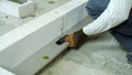 Checking evenness of aerated concrete wall with spirit level