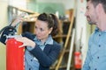 Checking fire extinguishers in warehouse Royalty Free Stock Photo