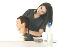 Checking Her Mannequin's Hair-Do Royalty Free Stock Photo