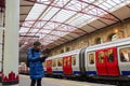 Checking her phone on the platform Royalty Free Stock Photo