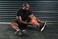 Checking on his calf injury. Studio shot of an athletic young man examining a calf injury during his workout.