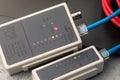 Checking the integrity of computer wires with a network cable tester, close-up of a LAN tester Royalty Free Stock Photo