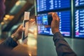 For checking later. an unrecognizable man taking a picture of a board in an airport. Royalty Free Stock Photo