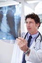 Checking out your x-rays. a male doctor looking at an x-ray. Royalty Free Stock Photo