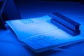 Checking the passport for fraud in UV and another light, detection of luminescence of protective components of the document (