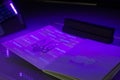 Checking the passport for fraud in UV light, detection of luminescence of protective components of the document threads, melange