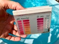 Checking pH level in blue outdoor pool