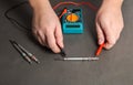 Checking the serviceability of the glow plug with a multimeter. Glow plug voltage resistance. Modern heating element Royalty Free Stock Photo