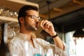 Pleasant handsome man putting a cork to his nose