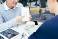 Checking stocks. Two business partners working on the laptop smiling cheerfully on a meeting at the local cafe - Image