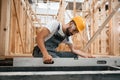 Checking the straight by using leveling tool. Industrial worker in wooden warehouse Royalty Free Stock Photo