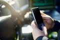 Checking is text alerts. an unrecognizable male police officer using his cellphone while out on patrol. Royalty Free Stock Photo