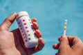 Checking the water quality of a pool with the help of a test strip with PH value, chlorine and algaecide Royalty Free Stock Photo