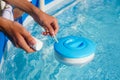 Checking the water quality of a pool with the help of a test strip with PH value, chlorine and algaecide Royalty Free Stock Photo