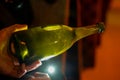 Checking of yeast in bottles, Champagne sparkling wine production in bottles in racks in underground cellar, Reims, Champagne,