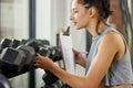 Checklist, fitness and inspection with personal trainer woman checking equipment or weights in gym. Dumbbell, exercise Royalty Free Stock Photo