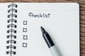 Checklist with marker pen and check box on small notepad on wood table, to do list, prioritize or reminder for project or plan Royalty Free Stock Photo