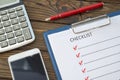 Checklist, pen with a fountain pen, a piece of paper on a wooden background. Royalty Free Stock Photo