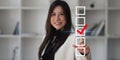 Checklist and Quality Assurance Concept. Businessman marks on check box with red check mark