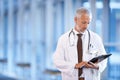 Checklist, serious doctor and man reading in hospital for healthcare, wellness and notes. Clipboard, medical Royalty Free Stock Photo