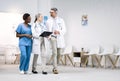 Checklist, team of doctors and nurse in discussion, planning and walking in hospital. Group of medical workers on Royalty Free Stock Photo