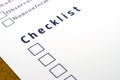 Checklist with a ticked box on white paper.