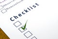 Checklist with a ticked box on white paper.