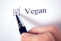 Checklist with a word Vegan on white paper. Checkbox and lifestyle concept