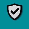 A checkmark symbol on a shield against a teal background. Royalty Free Stock Photo