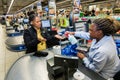 Checkout cashier staff spraying customer hands with disinfectant at Pick `n Pay grocery store during virus outbreak Royalty Free Stock Photo