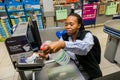 Checkout cashier staff wiping down credit card machine at Pick `n Pay grocery store during virus outbreak Royalty Free Stock Photo