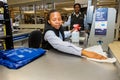 Checkout cashier staff wiping down surfaces at Pick `n Pay grocery store during virus outbreak Royalty Free Stock Photo