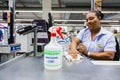 Checkout cashier staff wiping down surfaces at Pick `n Pay grocery store during virus outbreak Royalty Free Stock Photo