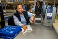 Checkout cashier staff wiping down surfaces at Pick `n Pay grocery store during virus outbreak Royalty Free Stock Photo