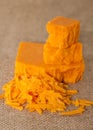 Cheddar cheese broken into hunks and grated. Royalty Free Stock Photo