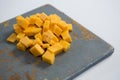 Cheddar cheese slices on cutting board Royalty Free Stock Photo