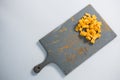 Cheddar cheese slices on cutting board Royalty Free Stock Photo