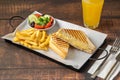 Cheddar cheese toast with french fries and salad on wooden table Royalty Free Stock Photo